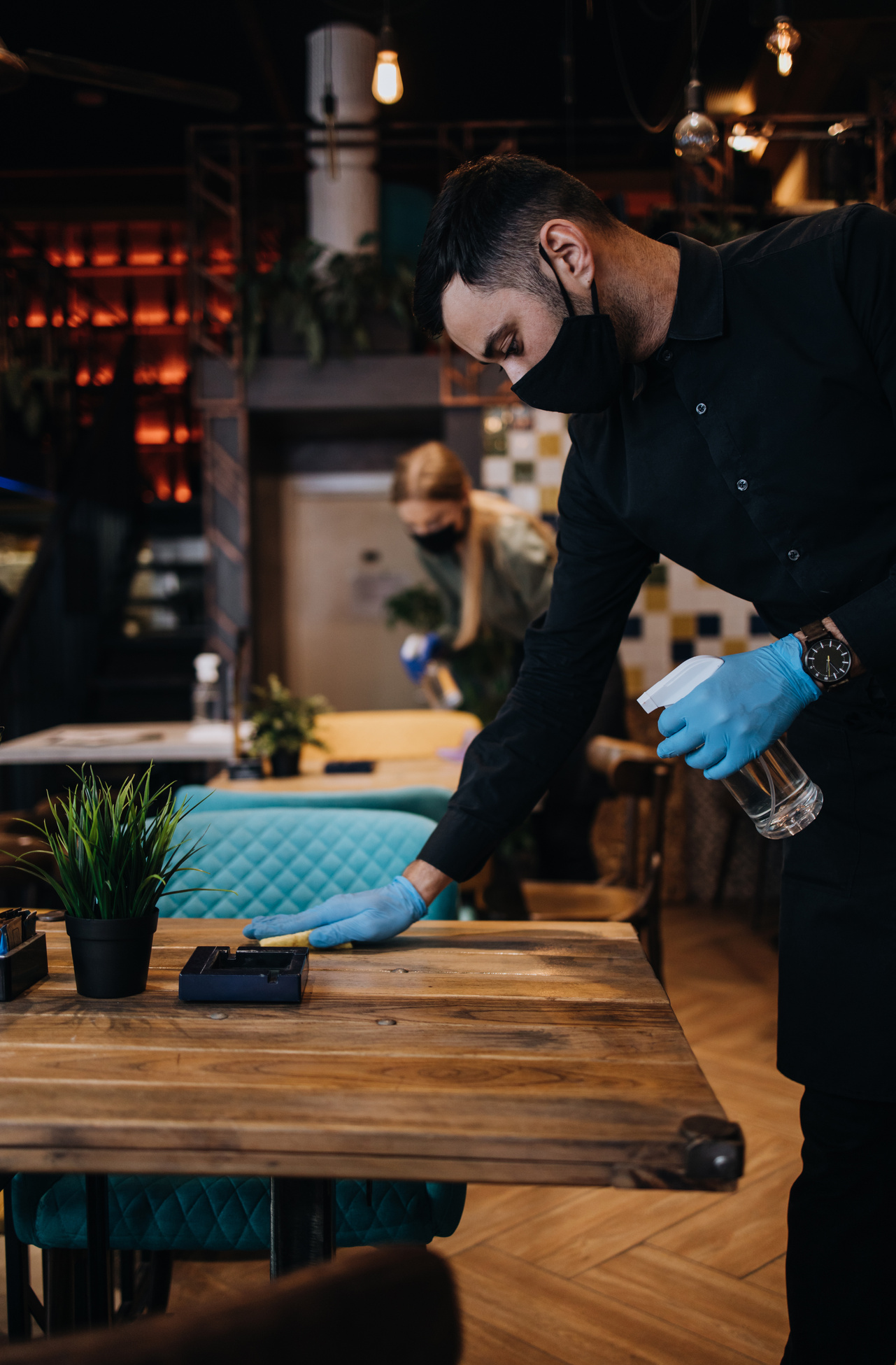 Restaurant workers disinfecting tables