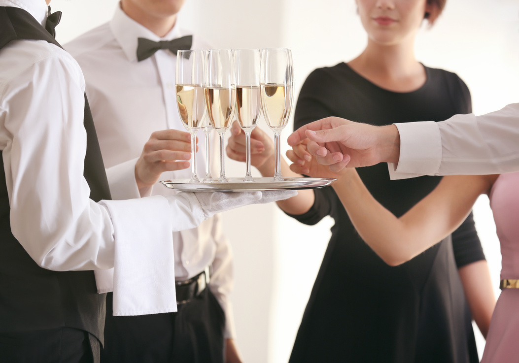 Waiter in Uniform Serving Champagne at Party